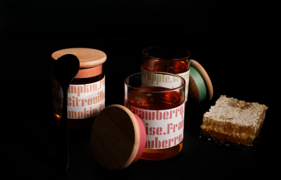 opened jars with spoon and honeycomb